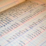 cahier ouvert avec écriture manuscrite et calculs sur papier quadrillé